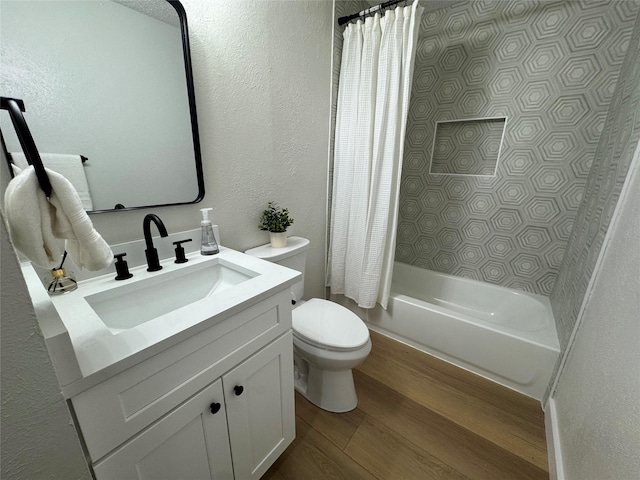 full bathroom featuring vanity, hardwood / wood-style floors, shower / tub combo with curtain, and toilet