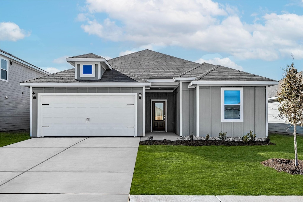 view of front of property with a garage and a front yard