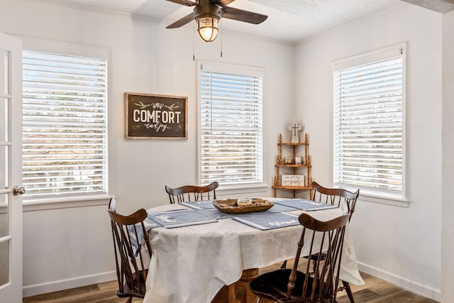 dining space featuring crown molding, a wealth of natural light, and wood-type flooring