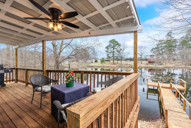 deck with a water view, ceiling fan, and grilling area