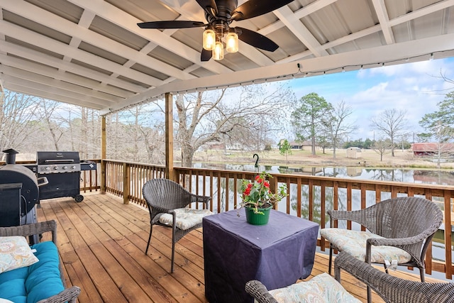 deck featuring a water view, a grill, outdoor lounge area, and ceiling fan