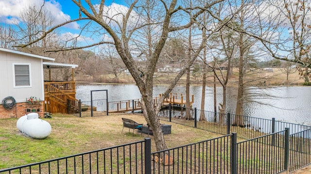 view of yard with a deck with water view