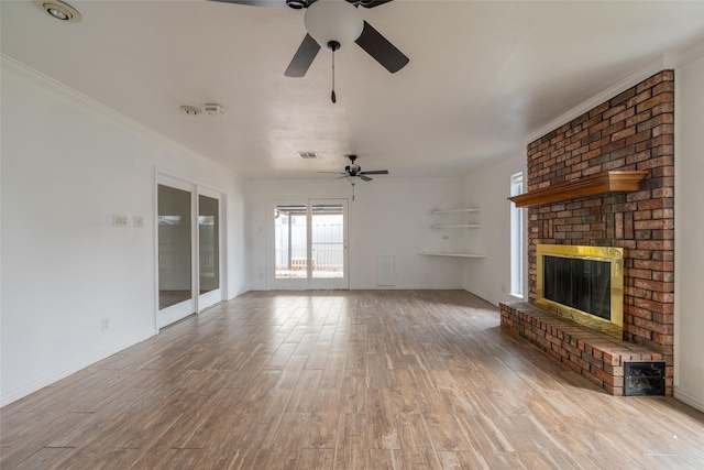 unfurnished living room with a fireplace, light hardwood / wood-style flooring, ornamental molding, and ceiling fan