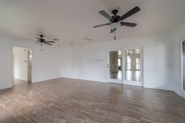 spare room featuring hardwood / wood-style flooring, crown molding, and ceiling fan