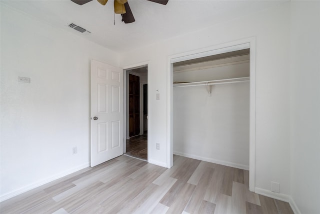 unfurnished bedroom featuring a closet, ceiling fan, and light wood-type flooring