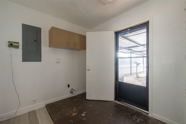 washroom featuring electric panel and a textured ceiling