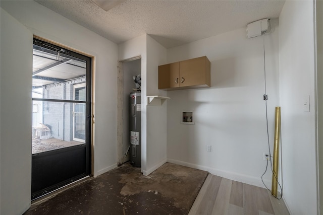 laundry room with washer hookup, electric water heater, a textured ceiling, and light wood-type flooring