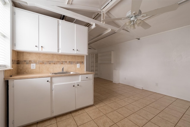 kitchen with sink, decorative backsplash, white cabinets, and ceiling fan