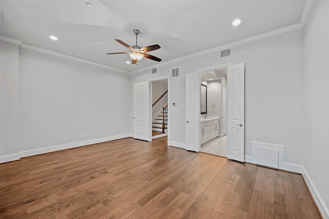 unfurnished bedroom featuring ornamental molding, light hardwood / wood-style floors, ceiling fan, and ensuite bathroom