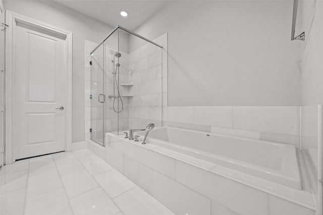 bathroom with tile patterned floors and plus walk in shower