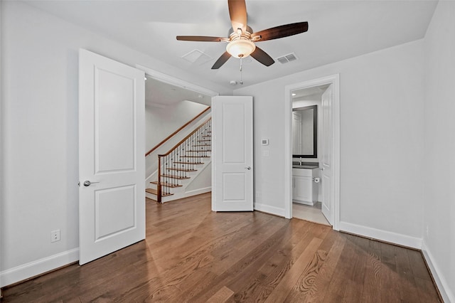 spare room featuring hardwood / wood-style flooring, sink, and ceiling fan