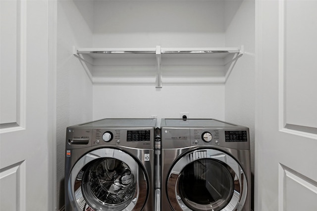 laundry room featuring washing machine and clothes dryer