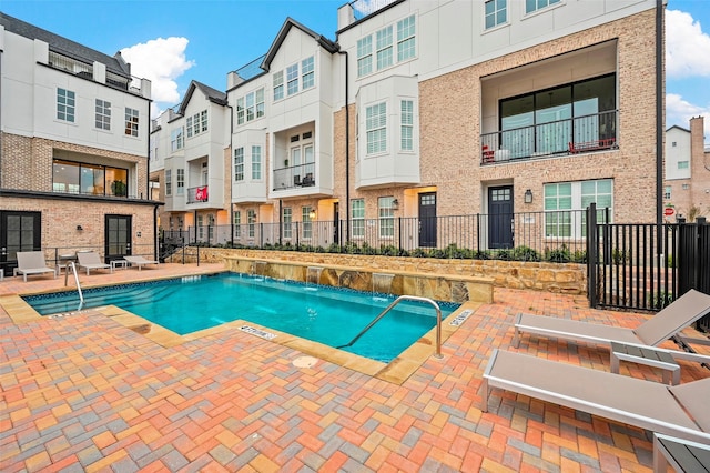 view of pool featuring pool water feature and a patio area