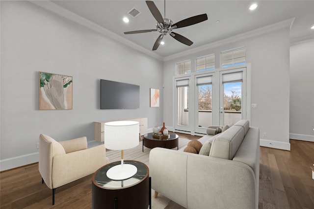 living room featuring dark wood-type flooring, ceiling fan, and ornamental molding