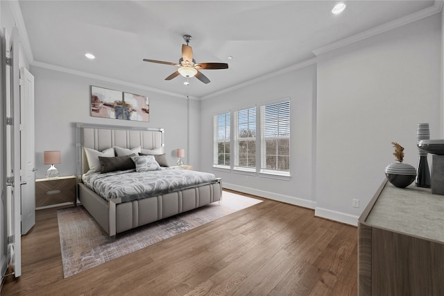 bedroom with crown molding, hardwood / wood-style floors, and ceiling fan