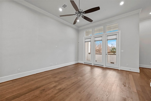 spare room with crown molding, wood-type flooring, and ceiling fan