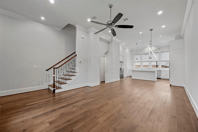 unfurnished living room with hardwood / wood-style flooring, ceiling fan, and ornamental molding