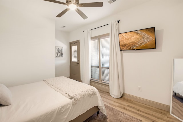 bedroom with hardwood / wood-style flooring and ceiling fan