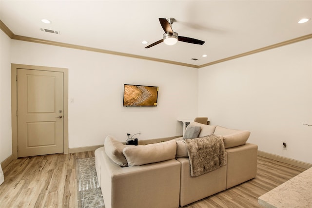 living room featuring crown molding, ceiling fan, and light wood-type flooring