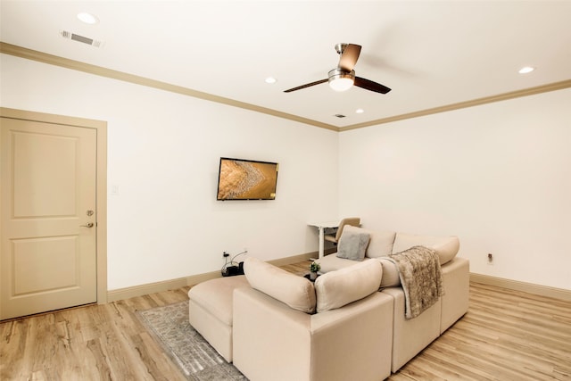 living room featuring crown molding, ceiling fan, and light wood-type flooring