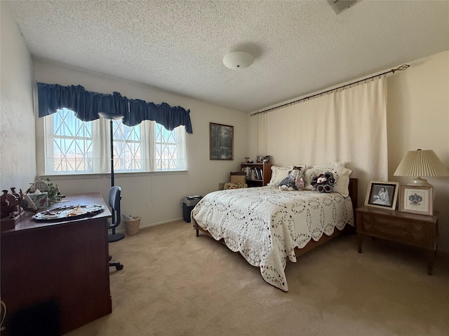 bedroom featuring a textured ceiling and carpet