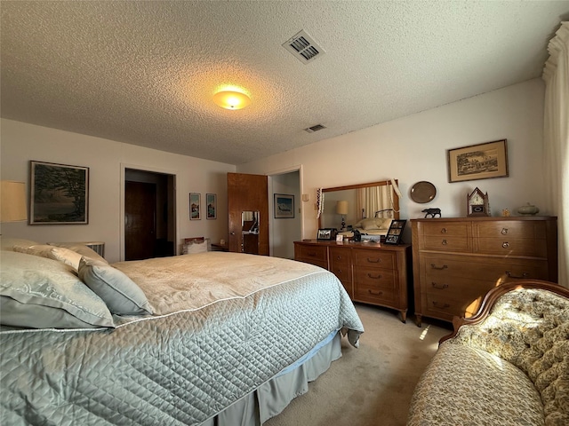 bedroom featuring light colored carpet and a textured ceiling