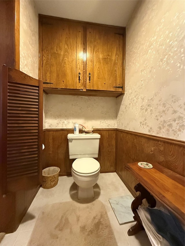 bathroom with wooden walls and toilet