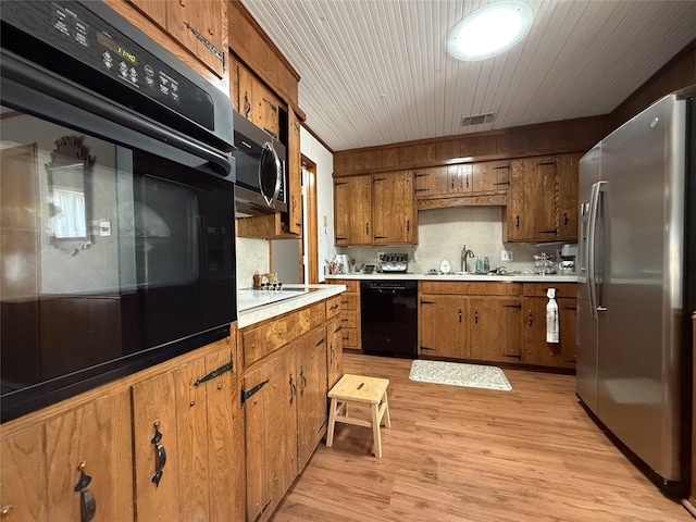 kitchen with sink, decorative backsplash, light hardwood / wood-style floors, black appliances, and wooden ceiling