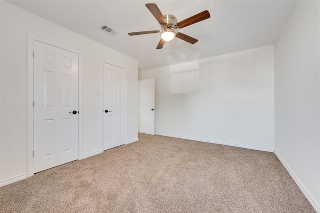 unfurnished bedroom with ceiling fan and carpet floors