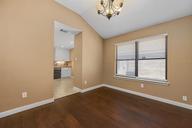 unfurnished room with hardwood / wood-style flooring, lofted ceiling, and a notable chandelier