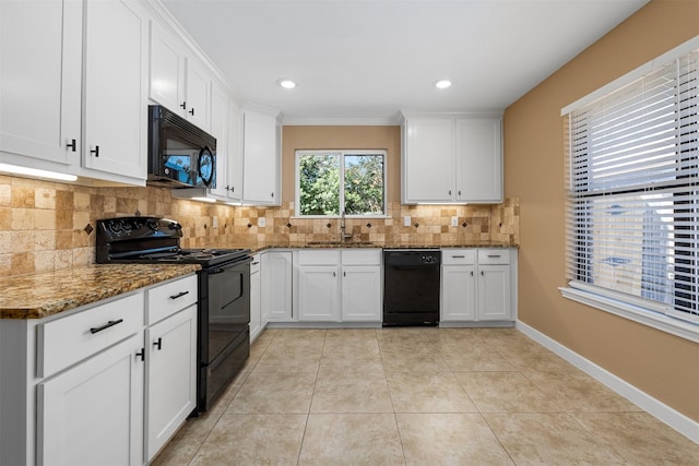 kitchen featuring sink, white cabinetry, dark stone countertops, decorative backsplash, and black appliances