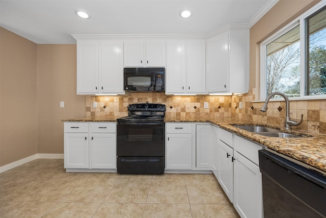 kitchen featuring sink, black appliances, dark stone countertops, white cabinets, and backsplash