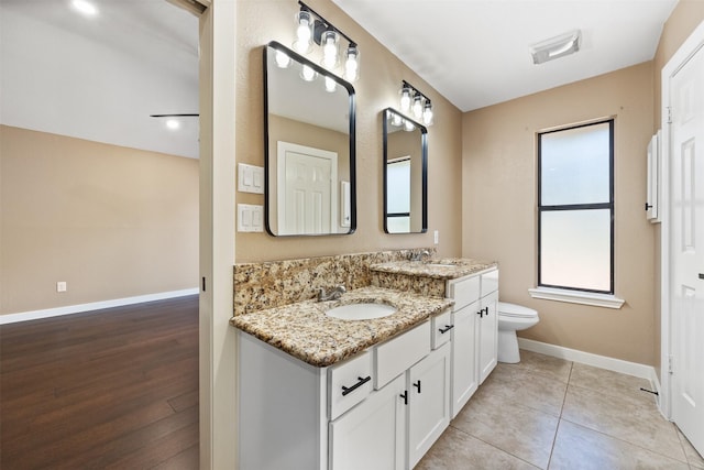 bathroom featuring vanity, tile patterned floors, and toilet