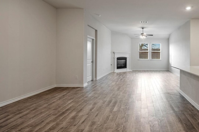 unfurnished living room featuring hardwood / wood-style flooring and ceiling fan