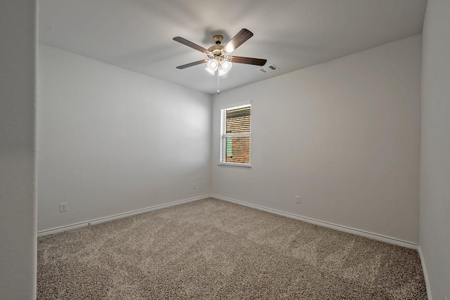 unfurnished room with ceiling fan and carpet