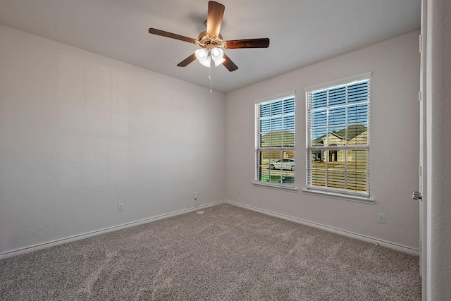 carpeted spare room featuring ceiling fan