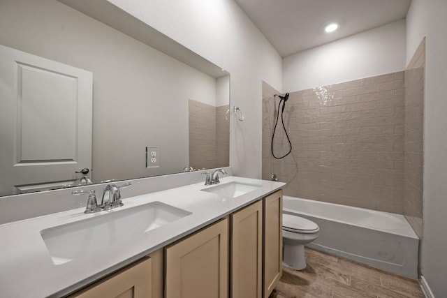 full bathroom featuring vanity, toilet, tiled shower / bath combo, and wood-type flooring