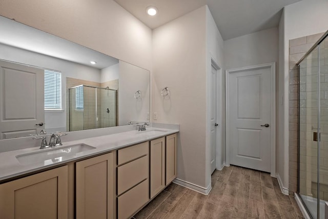 bathroom featuring wood-type flooring, vanity, and walk in shower