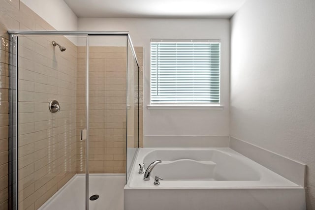 bathroom featuring shower with separate bathtub