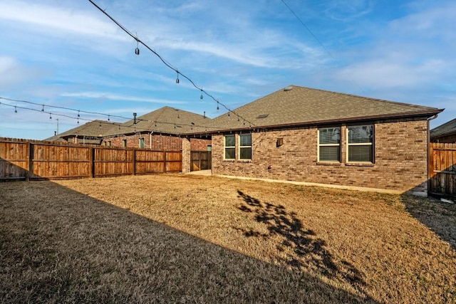 rear view of property featuring a lawn