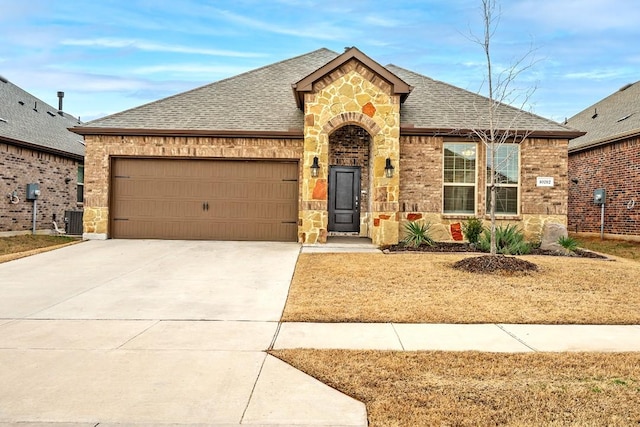 view of front facade with central AC and a garage