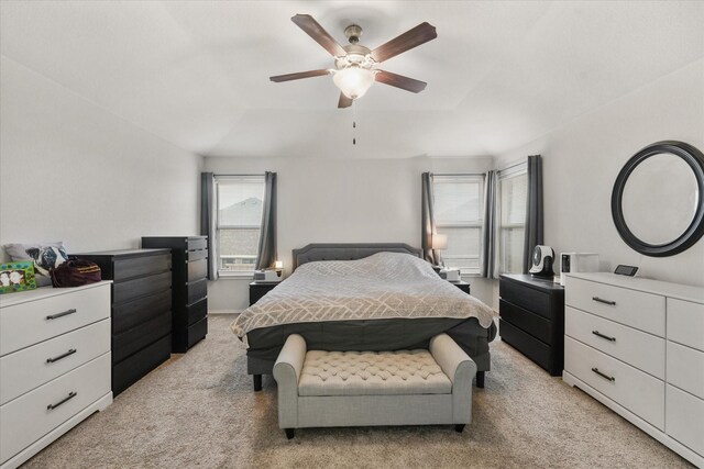 carpeted bedroom with lofted ceiling