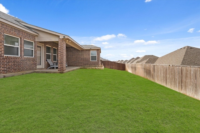 view of yard with a patio area and a fenced backyard