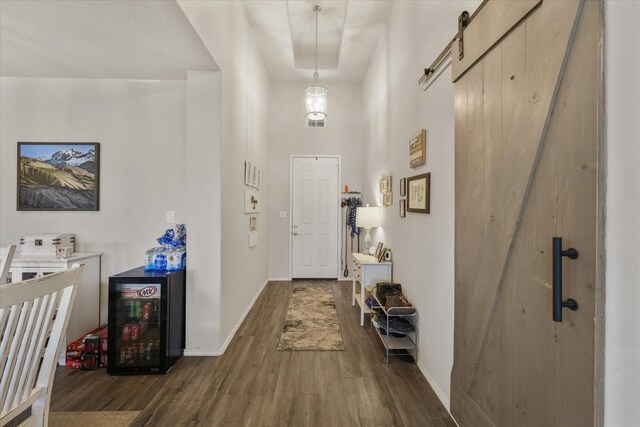 dining space featuring lofted ceiling with beams, sink, wine cooler, and dark hardwood / wood-style flooring