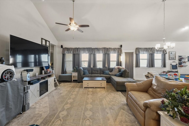 living room with high vaulted ceiling and ceiling fan with notable chandelier