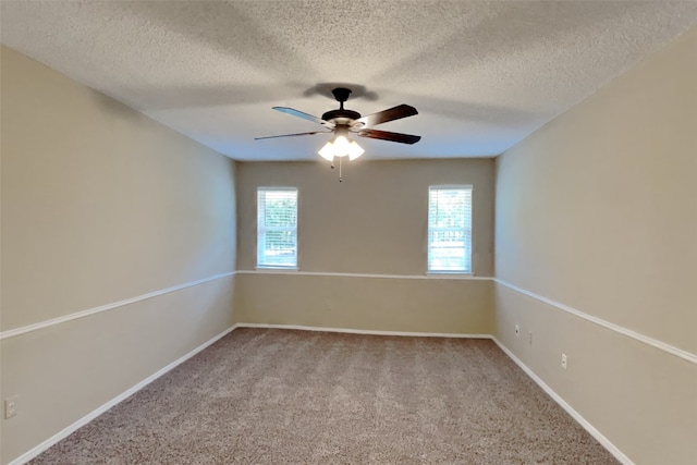 carpeted spare room featuring ceiling fan, plenty of natural light, and a textured ceiling