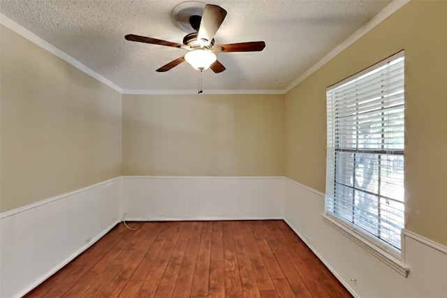 spare room with crown molding, dark hardwood / wood-style floors, and a textured ceiling