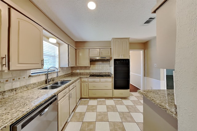 kitchen featuring tasteful backsplash, sink, black appliances, and light stone countertops