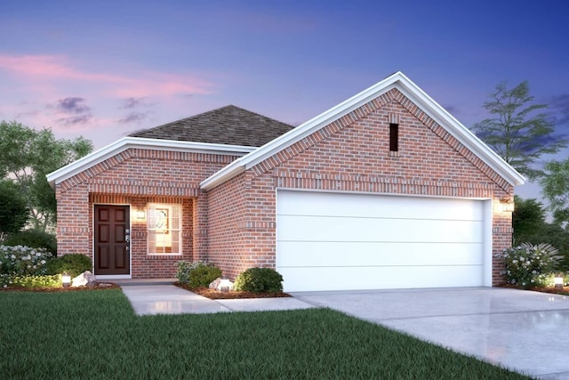 view of front of house featuring a garage and a lawn