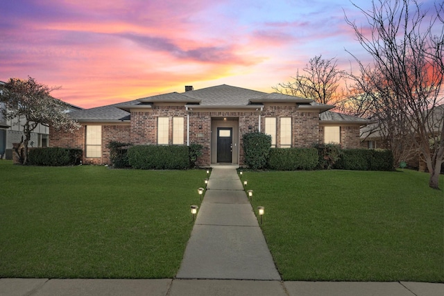 prairie-style home with a yard